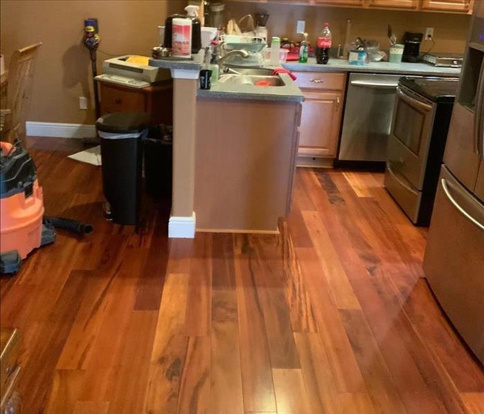 A kitchen with wood floors.