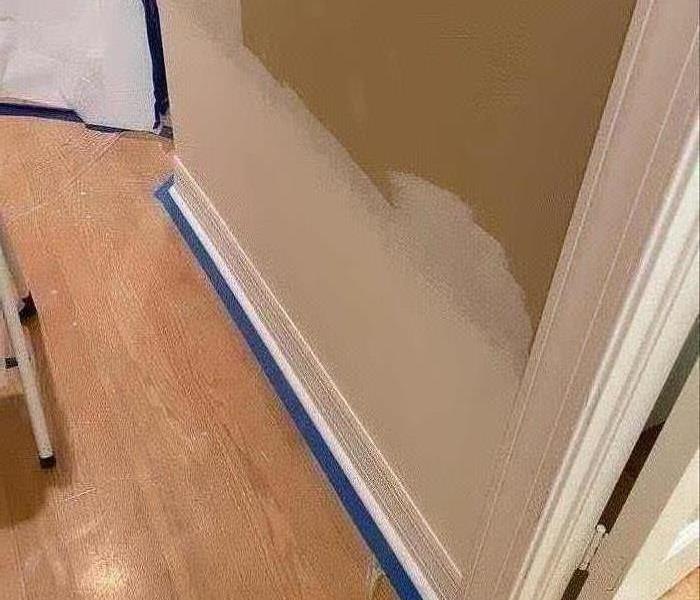 Tan wall that has been sealed with white paint. 