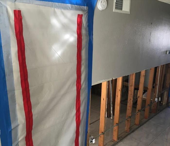 Wall taped up with containment and flood cuts. 