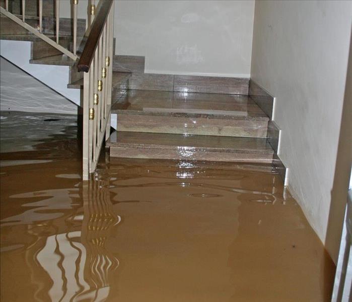 Floodwaters enters a home, water reaches the stairs from the house