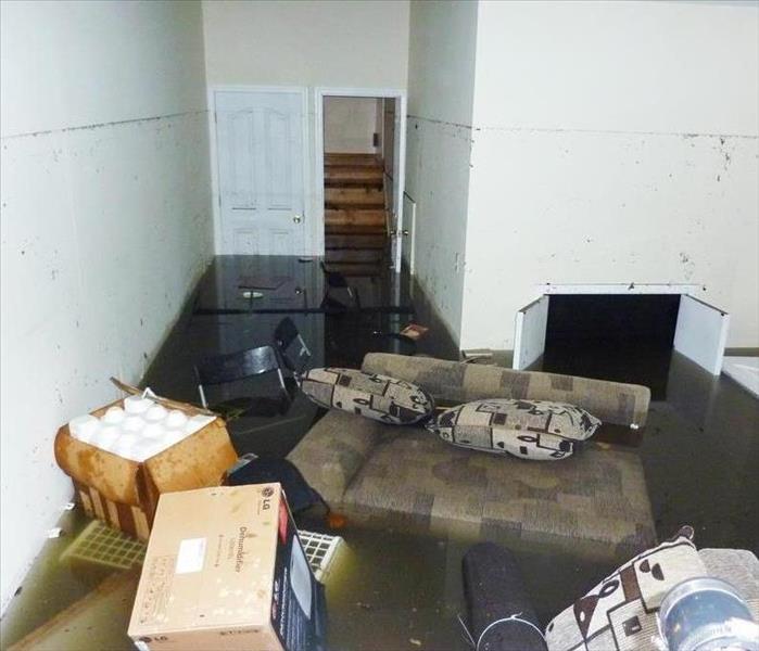 Flooded room with floating furniture. 