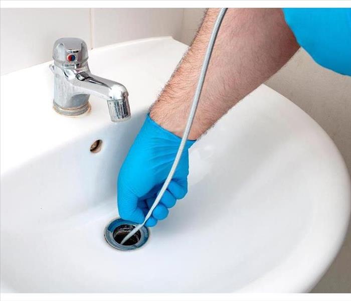 Plumbing issues, sanitation occupancy and the concept of artisan contractor with plumber repairing lead-in-lead drain